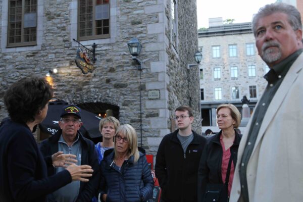 Combo Historical and Food tour of Old Quebec City, group focused on guide's presentation in the Place Royale
